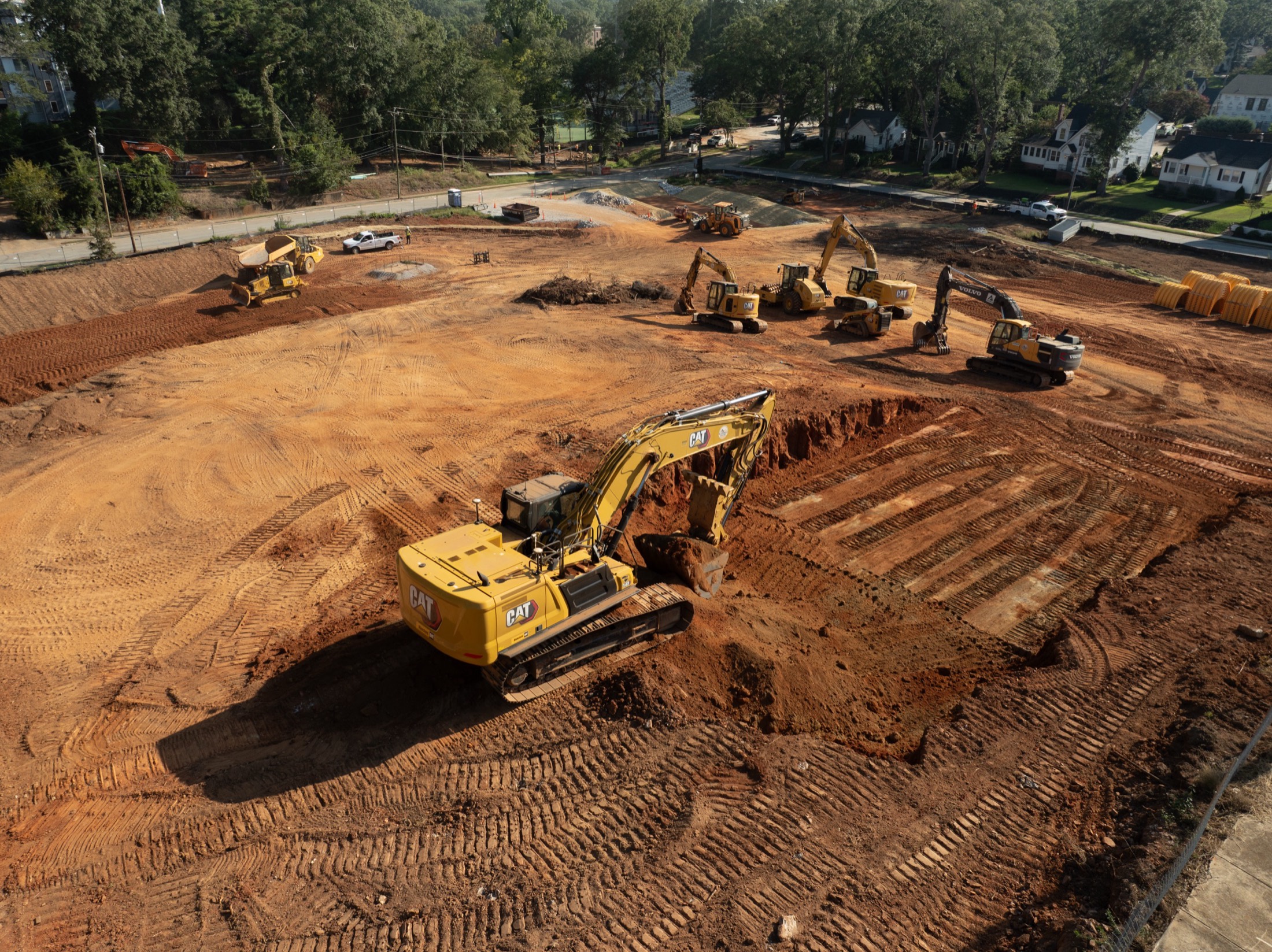 Alexander Grading excavator moving red clay at golden hour